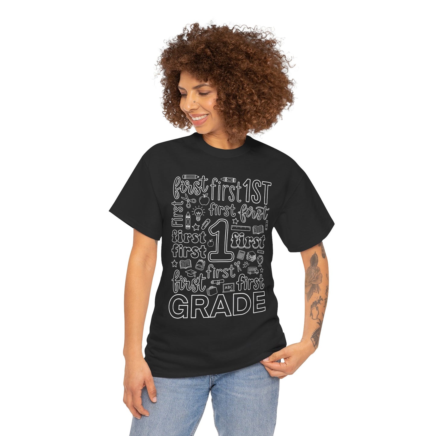 Woman first grade teacher wearing a black TEEZOCA typography t-shirt reading first grade, a cute back to school tee for teachers.
