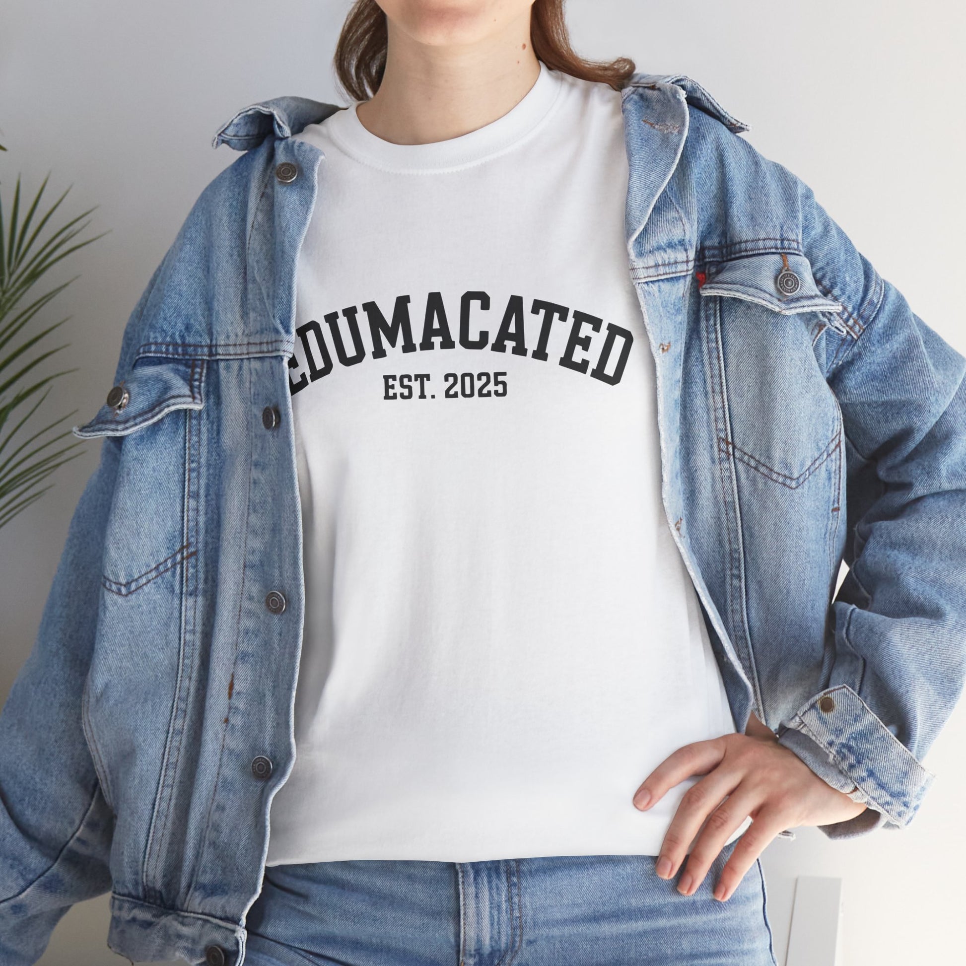 Woman in a denim jacket styling a white TEEZOCA Edumacated Est. 2025 tee.