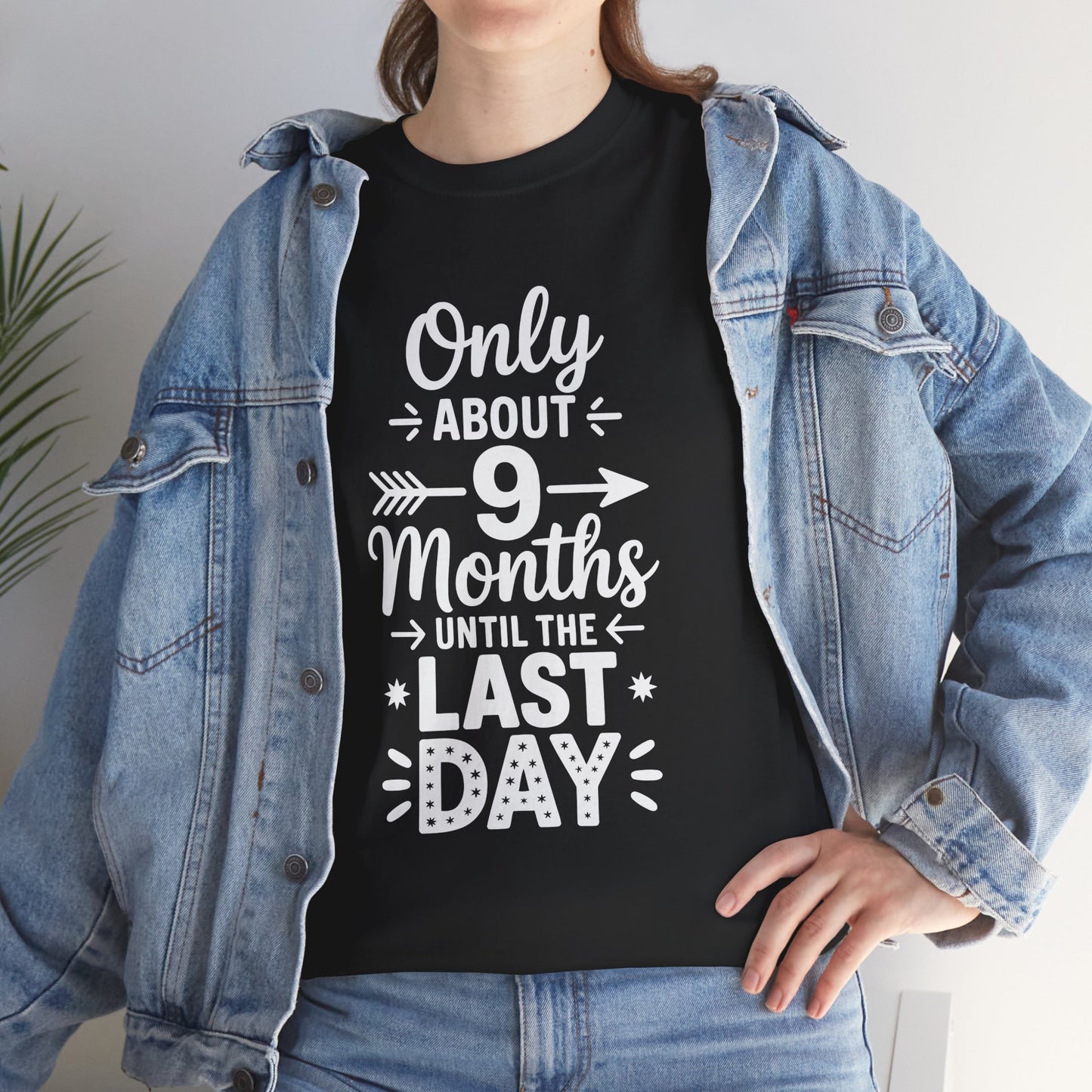 Woman wearing TEEZOCA black “9 Months to Last Day” teacher shirt under denim jacket.