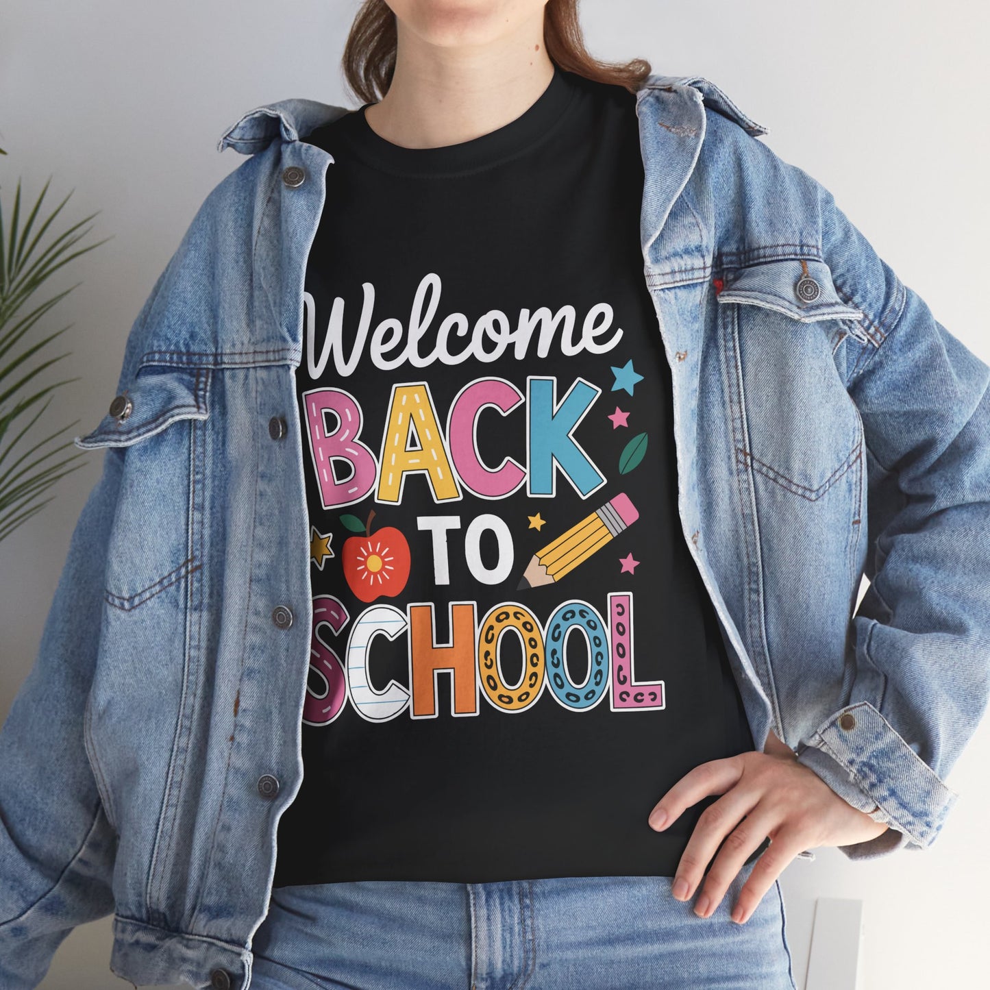Woman wearing TEEZOCA black “Welcome Back To School” tee under denim jacket.