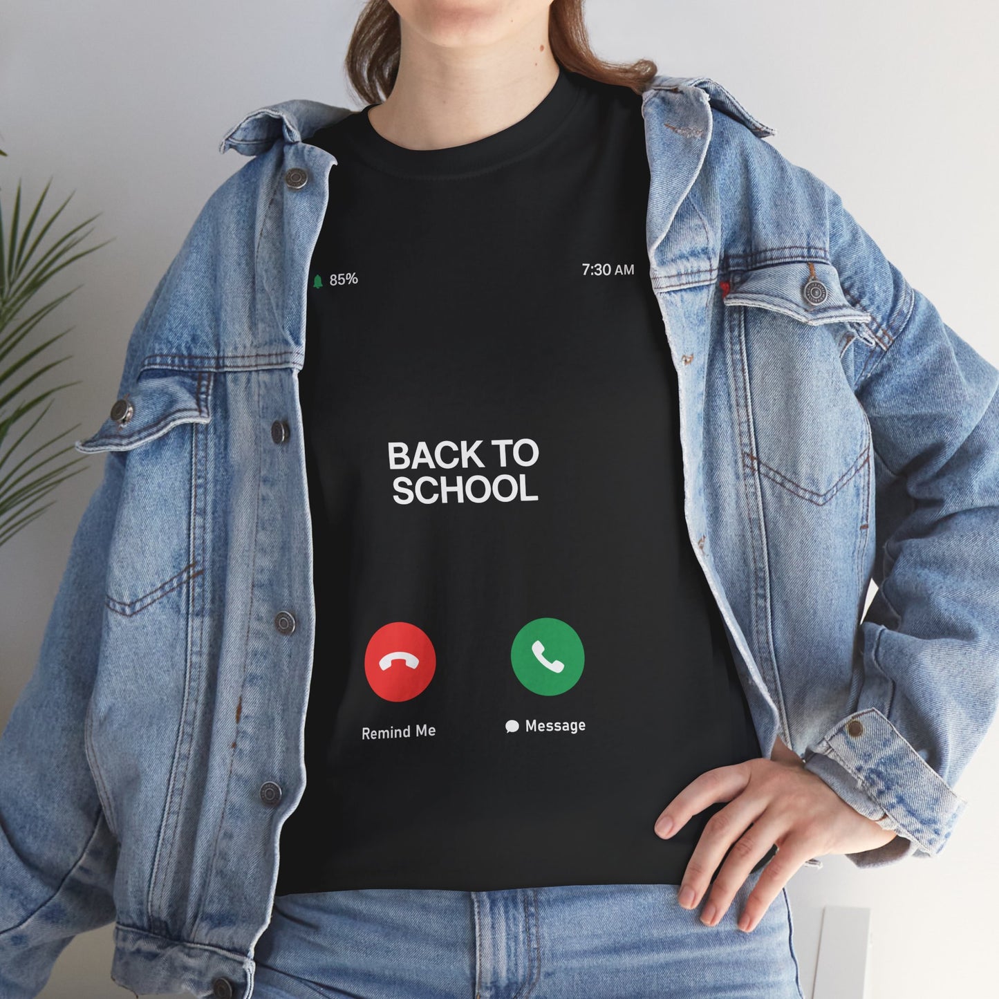 Woman wearing TEEZOCA black back to school phone tee under denim jacket.
