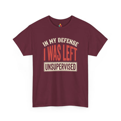 a Maroon T-shirt featuring the phrase “In My Defense I Was Left Unsupervised” in bold red and cream retro-style text, funny sarcastic quote shirt, witty statement tee, dry humor graphic tee, adult humor apparel, retro typography shirt, bold statement shirt, playful sarcasm tee, humorous quote t-shirt, chaos humor shirt, and funny novelty graphic tee.

