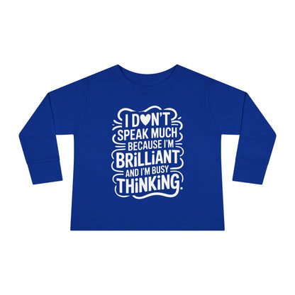 Royal blue toddler long sleeve autism awareness shirt with white “I don’t speak much because I’m brilliant and I’m busy thinking” quote for quiet smart kids.