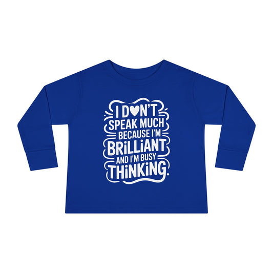 Royal blue toddler long sleeve autism awareness shirt with white “I don’t speak much because I’m brilliant and I’m busy thinking” quote for quiet smart kids.