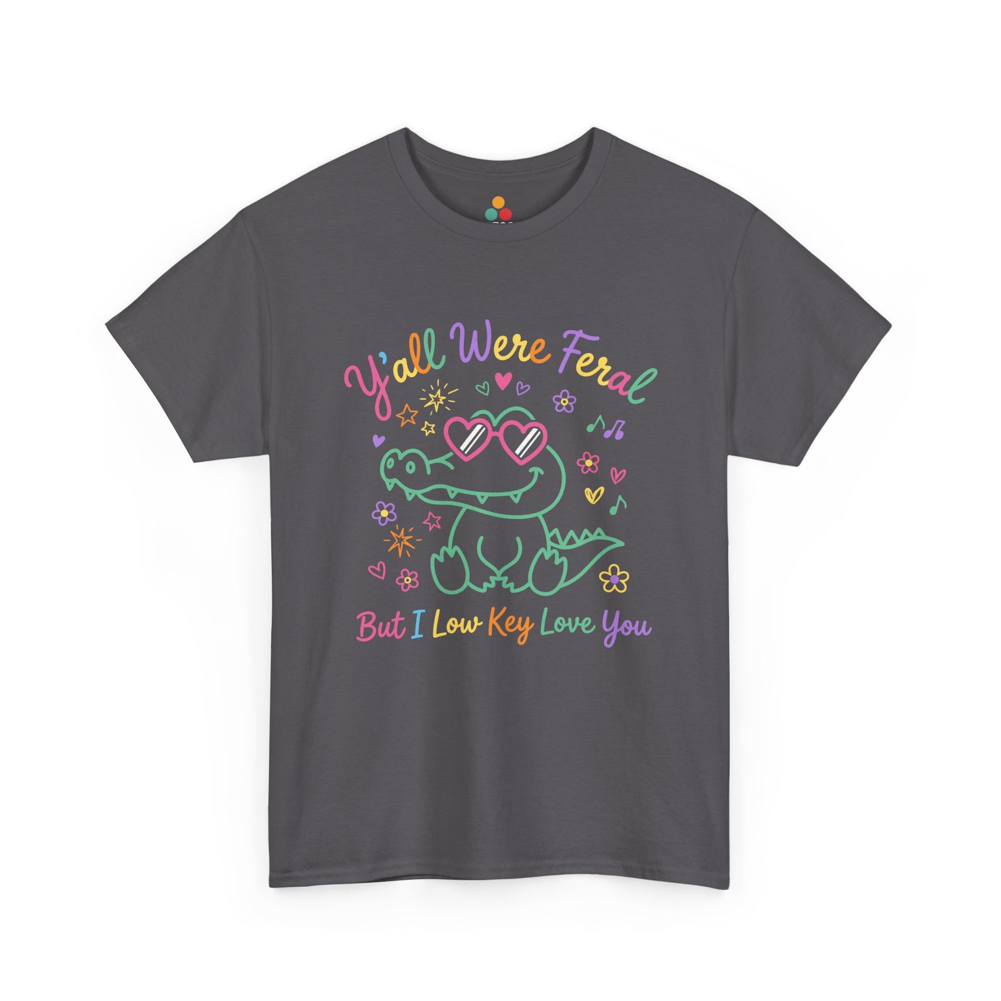 funny t-shirt  crocodile wearing heart-shaped sunglasses surrounded by colorful stars and flowers, with rainbow text reading "Y'all Were Feral But I Low Key Love You" — a funny last day of school teacher gift shirt.

