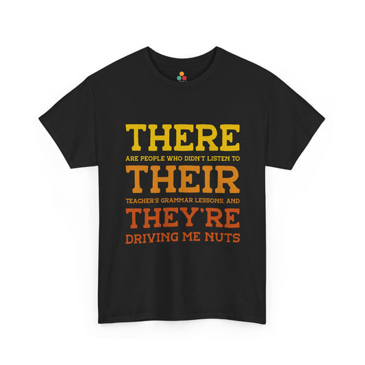 Black t-shirt with large yellow and orange text—“There, Their, They’re Driving Me Nuts”—funny grammar gift for English teachers, language lovers, and classroom humor.