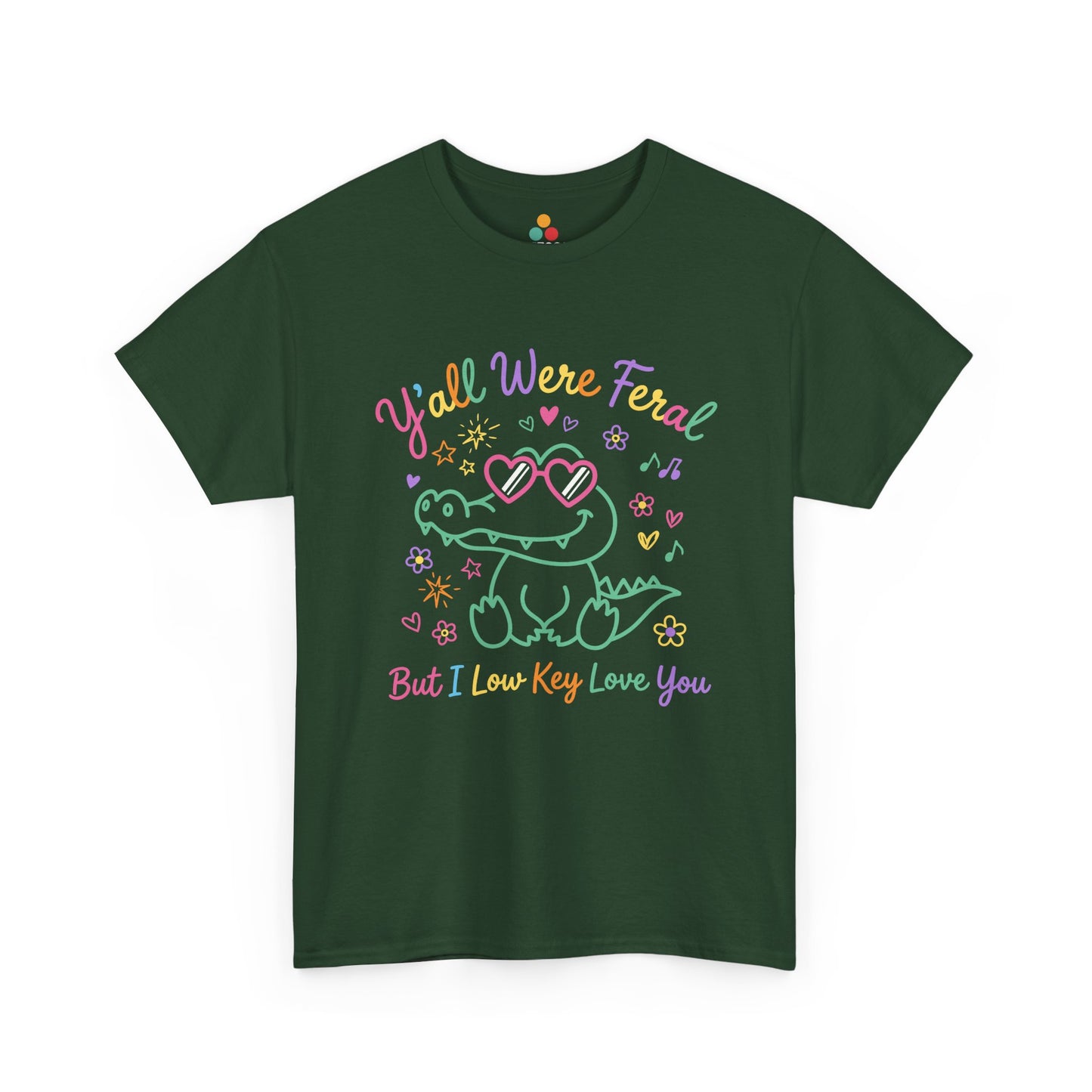 green forest T-shirt featuring a cute neon crocodile wearing heart-shaped sunglasses surrounded by colorful stars and flowers, with rainbow text reading "Y'all Were Feral But I Low Key Love You" — a funny last day of school teacher gift shirt.

