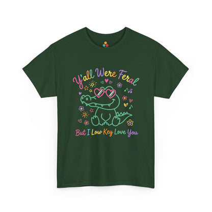 green forest T-shirt featuring a cute neon crocodile wearing heart-shaped sunglasses surrounded by colorful stars and flowers, with rainbow text reading "Y'all Were Feral But I Low Key Love You" — a funny last day of school teacher gift shirt.

