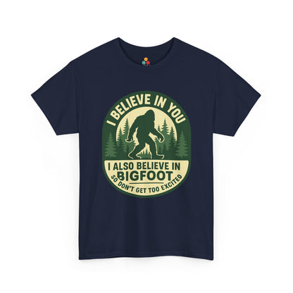  “Teezoca navy blue cryptid tee, I Believe In You I Also Believe In Bigfoot, pine trees, front view”

