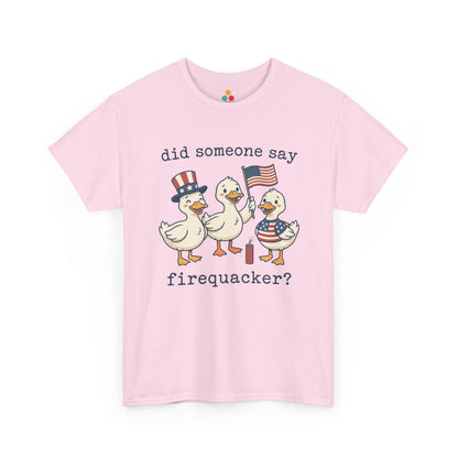 Pink TEEZOCA T-shirt featuring three cartoon patriotic ducks — one in an Uncle Sam hat, one holding a US flag, and one in a stars-and-stripes outfit — around a firecracker with the text "did someone say firequacker?" printed above and below.

