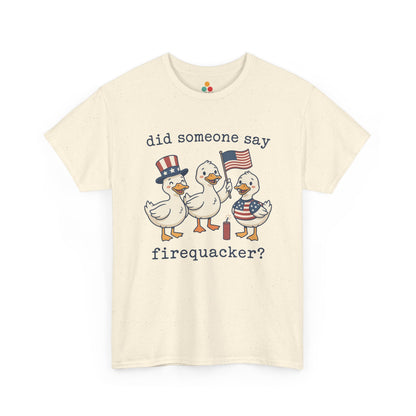 sand beige  TEEZOCA T-shirt featuring three cartoon patriotic ducks — one in an Uncle Sam hat, one holding a US flag, and one in a stars-and-stripes outfit — around a firecracker with the text "did someone say firequacker?" printed above and below.

