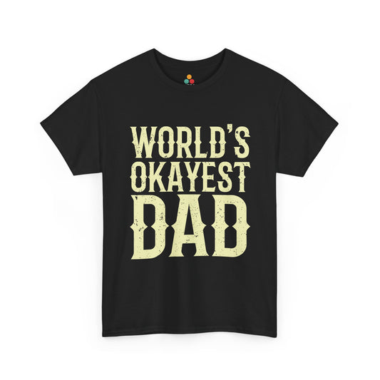 Black “WORLD’S OKAYEST DAD” bold cream text T‑shirt, flat front product mockup.